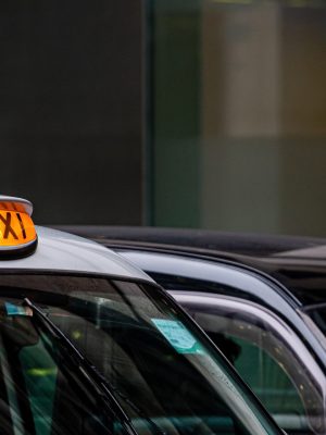 A british london black taxi cab sign with defocused  background - image