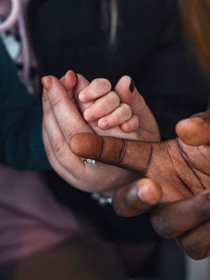 interracial-families-parents-hold-the-child-s-han-2025-01-09-12-35-20-utc