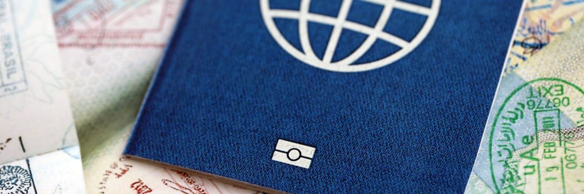 Many open passport pages with lots of visas and entrance stamps from various countries passport control. Concept of travel and tourism worldwide