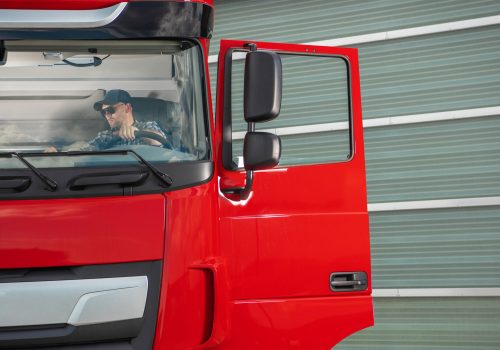 Transportation Industry Theme. Caucasian Professional Trucker in His 40s Inside His Truck Cabin Preparing For a Route